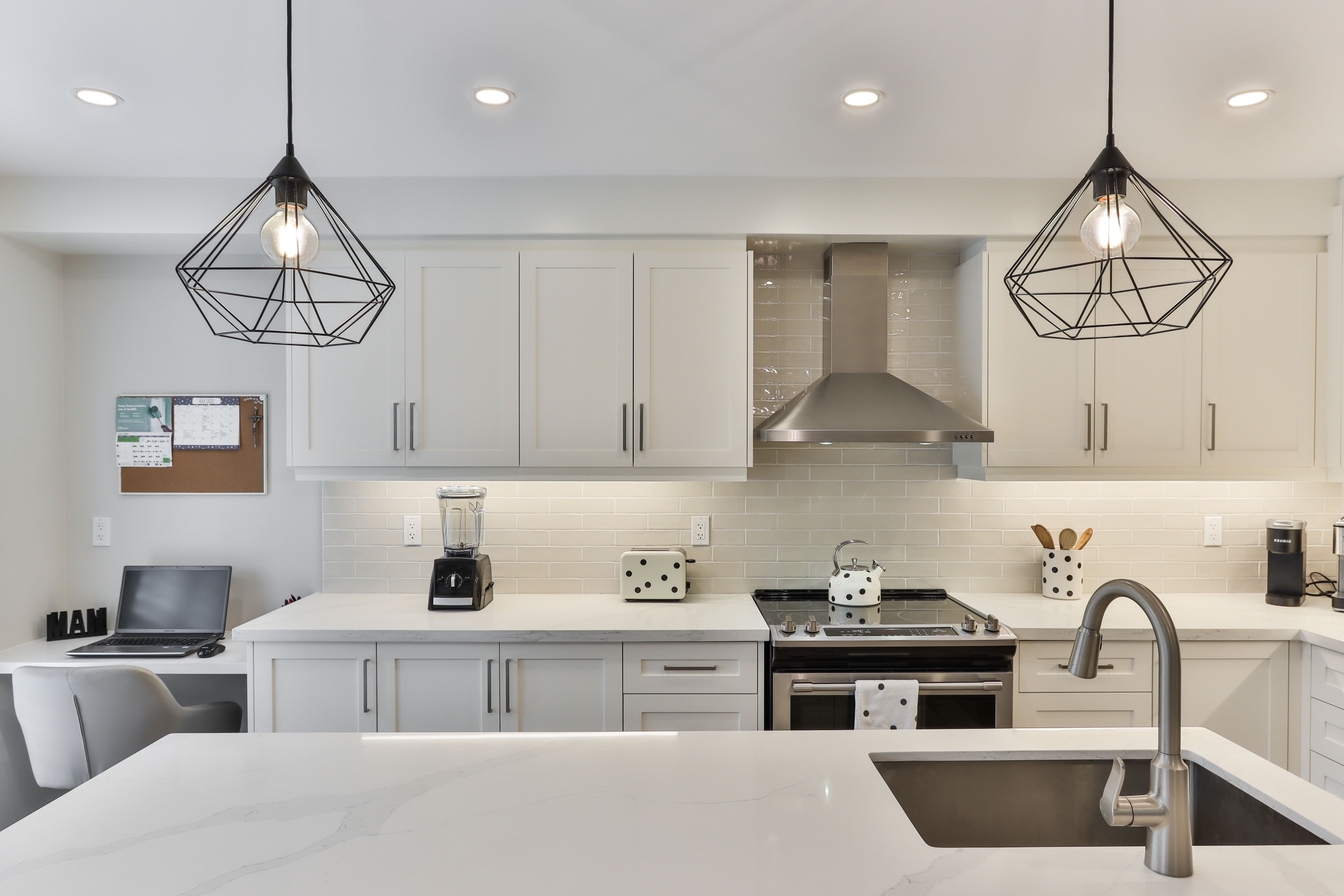 white wooden kitchen cabinet with black pendant lamp